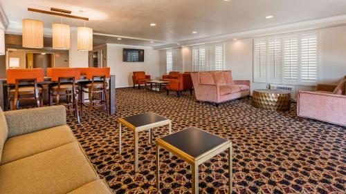 a living room with furniture and a dining room at Lompoc Valley Inn and Suites in Lompoc