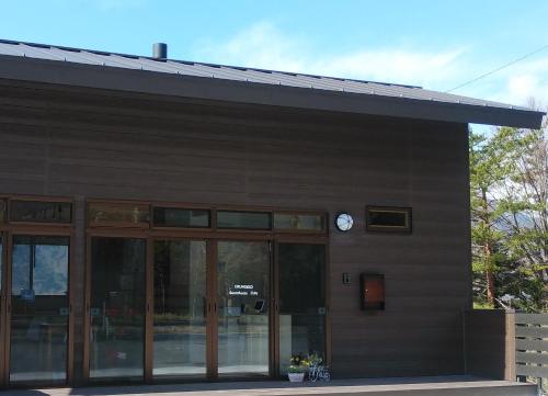 a building with a clock on the side of it at Okunikko Guesthouse JUN in Nikko