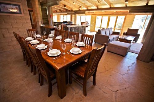 a large wooden table and chairs in a living room at Snowy Wilderness in Ingebyra