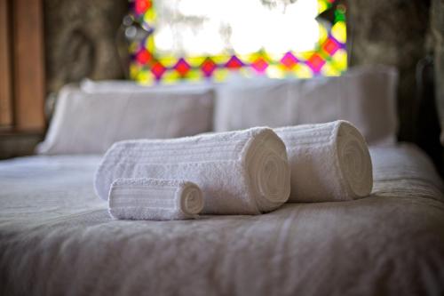 three rolled up towels sitting on a bed at Snowy Wilderness in Ingebyra