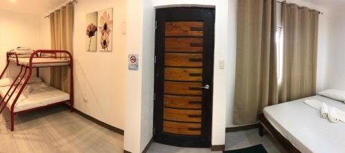 a room with a door leading to a bedroom at Seabreeze Beach Lodge in Nasugbu