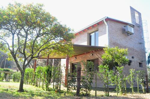 a house with a fence in front of it at Los Olivos Loft in Rosario