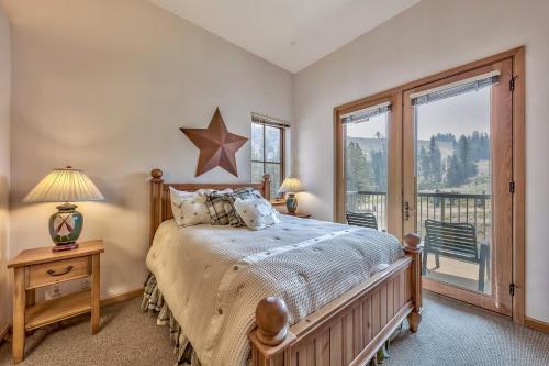 een slaapkamer met een bed en een groot raam bij L306 Kirkwood Lodge in Kirkwood