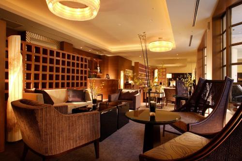 a lobby with couches and chairs and a table at Hotel Chinzanso Tokyo in Tokyo