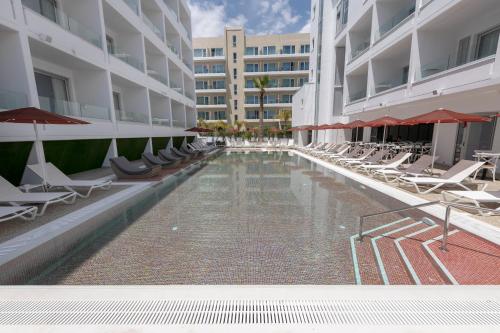 a swimming pool in the middle of a building at Kokkinos Boutique Hotel in Protaras