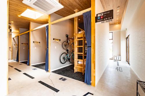 a room with a bike on the wall at I-Link Hostel & Cafe Shimanami in Imabari