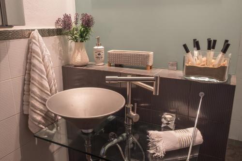 a bathroom with a sink and a counter at Relux Suite in Agios Nikolaos