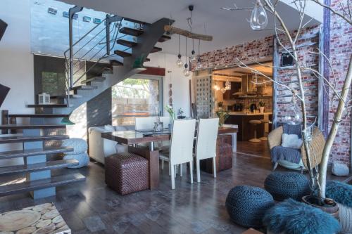a dining room with a staircase and a table and chairs at Relux Suite in Agios Nikolaos