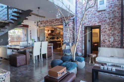 a living room with a brick wall at Relux Suite in Agios Nikolaos