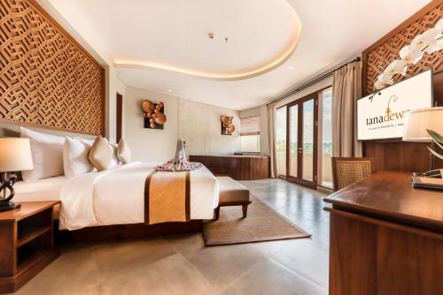 a hotel room with a bed and a desk at tanadewa Resort Ubud Bali by Cross Collection in Ubud