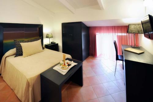 a bedroom with a bed and a table with a tray of food at Relais Villa Buonanno in Cercola