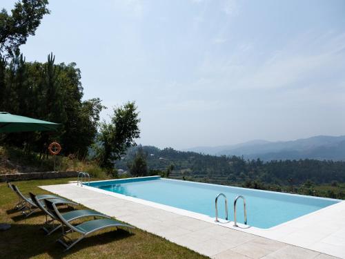 a swimming pool with a view of the mountains at Quinta do Bárrio - Manor Guest House in Terras de Bouro