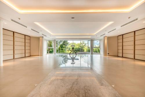 an empty hall with doors and a table in the middle at tanadewa Resort Ubud Bali by Cross Collection in Ubud