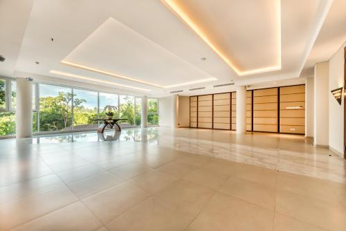 a large room with a woman sitting on a table in the middle at tanadewa Resort Ubud Bali by Cross Collection in Ubud