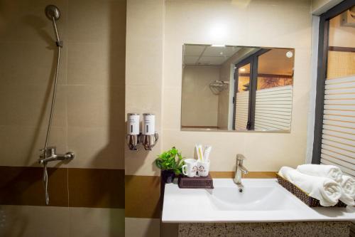 a bathroom with a sink and a mirror at Cozi 9 Hotel in Hai Phong