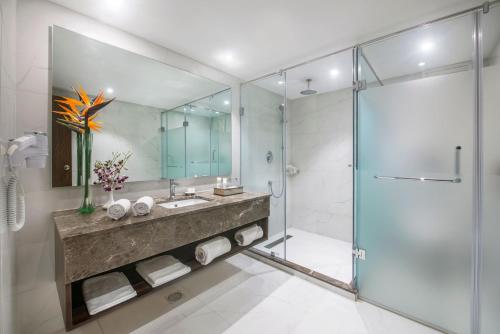 a bathroom with a sink and a shower at Royal Orchid Resort & Convention Centre, Yelahanka Bangalore in Bangalore