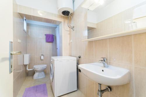a bathroom with a sink and a toilet at Apartment Kneže in Račišće