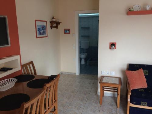 a living room with a table and a dining room at Aegean Villas in Potos