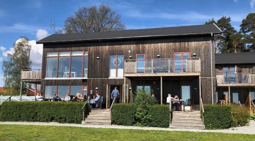 a building with people sitting outside of it at Bodelssons by the Sea in Tosteberga