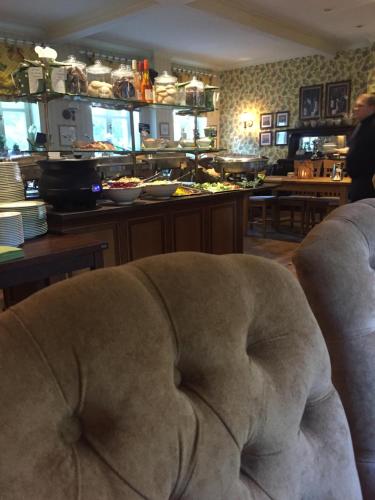 a couch sitting in a living room with a bar at Haus Honigstal Landhaus Café in Wuppertal