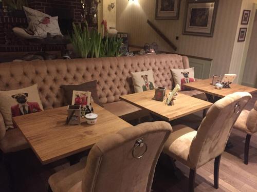 two wooden tables and chairs in a restaurant at Haus Honigstal Landhaus Café in Wuppertal