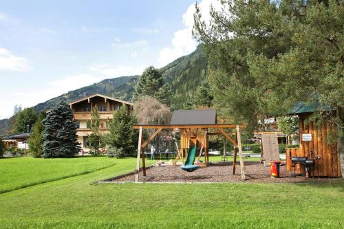 a playground with a swing set in a park at Gästehaus Trixl in Zell am See