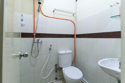 a bathroom with a toilet and a sink at Hotel Celia in Samarinda
