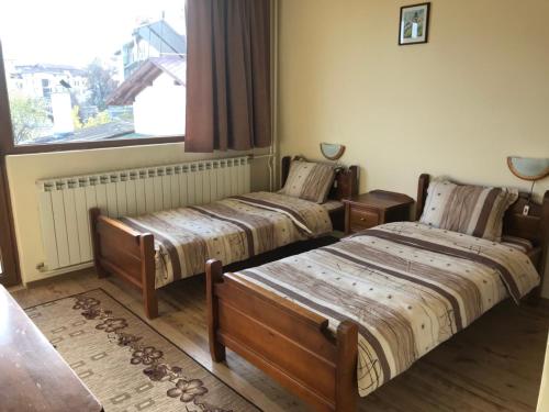 Postel nebo postele na pokoji v ubytování Hadji Georgi Hotel
