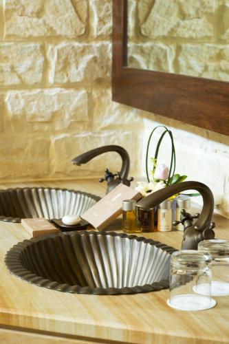 a kitchen counter with a sink and a counter top with a sink at Philea Resort & Spa in Malacca