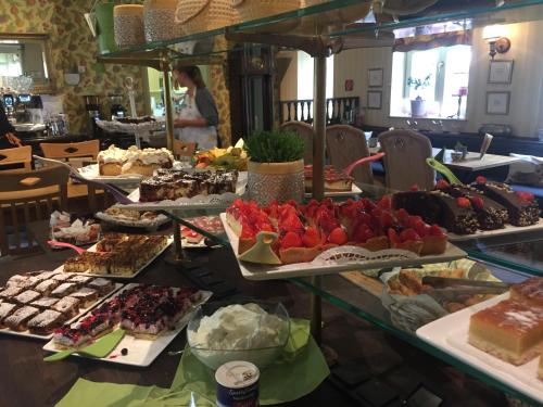 a buffet filled with lots of different types of desserts at Haus Honigstal Landhaus Café in Wuppertal