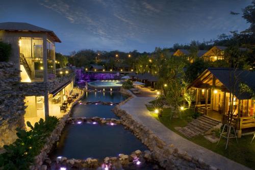 an aerial view of a resort pool at night at Philea Resort & Spa in Melaka
