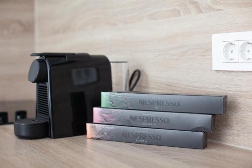 a stack of books sitting next to a printer at Apartments Coast 27 in Podgora
