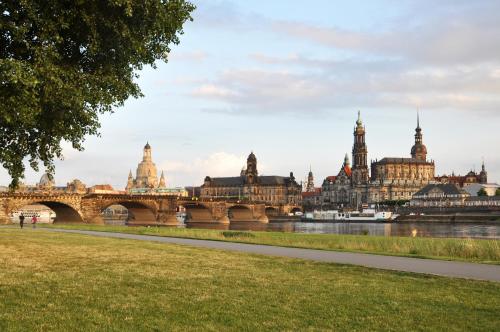 a bridge over a river in a city with buildings at Best Western Macrander Hotel Dresden in Dresden