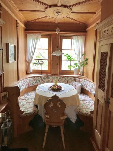 a dining room with a table and a chair at Garni Hotel Burgleitenhof in Lana