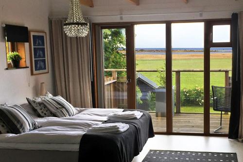 a living room with a couch and a large window at Bodelssons by the Sea in Tosteberga