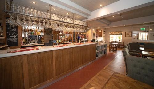 a bar in a restaurant with a counter and chairs at The Farrier in Scarborough