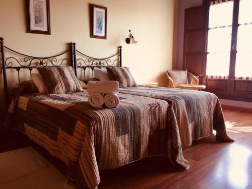 a bedroom with a bed with two teddy bears on it at APARTAMENTOS RURALES AZABACHE in Villaviciosa