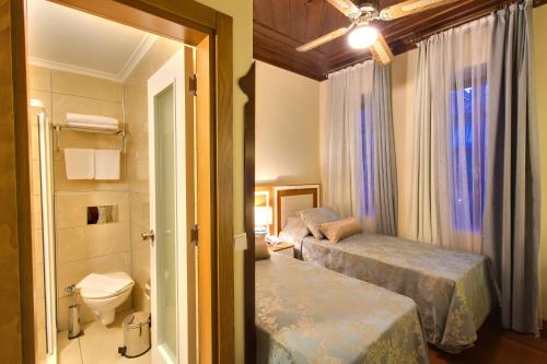 a hotel room with two beds and a bathroom at Dogan Hotel in Antalya
