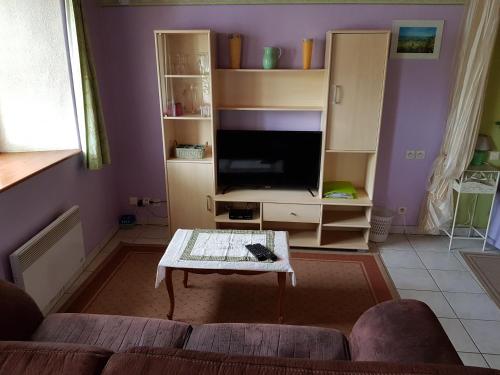 a living room with a couch and a coffee table at La Maison Jaune in Ammerschwihr