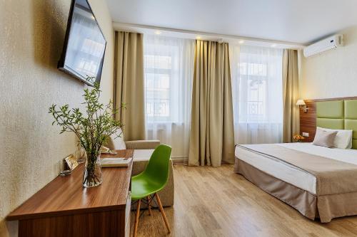 a hotel room with a bed and a desk at Regina Hotel in Saint Petersburg