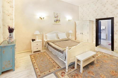 a bedroom with a white bed and a blue cabinet at Hotel Regal 1880 - Boutique Hotel in Parcul Central Sinaia in Sinaia