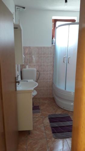 a bathroom with a white toilet and a sink at Guest House Šobić in Šipovo