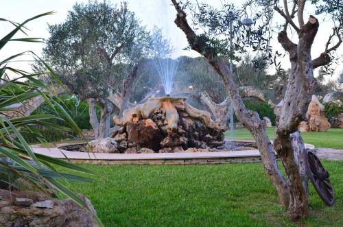 a fire pit in the middle of a park at Masseria Grande in Taurisano