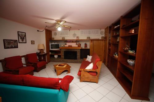 a living room with a blue couch and red chairs at B&B Villa Maria in Agropoli