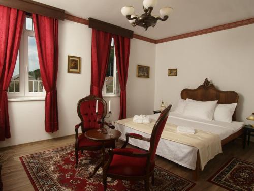 a bedroom with a bed and a table and chairs at Hotel Puntijar in Zagreb