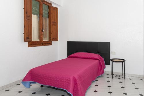 Ein Bett oder Betten in einem Zimmer der Unterkunft La Ponderosa, 4º-21