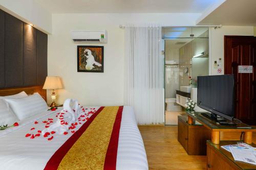 a hotel room with a bed and a television at Saigonciti Hotel A in Ho Chi Minh City