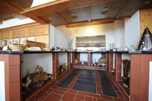 a large kitchen with a large counter in a room at Behringers City Hotel Nürnberg in Nuremberg
