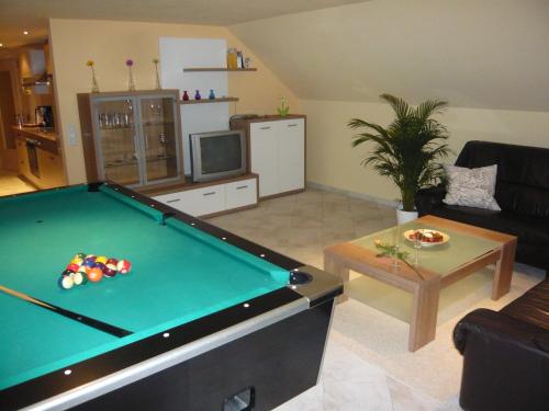 a living room with a pool table at Pummpälzhof in Bad Salzungen