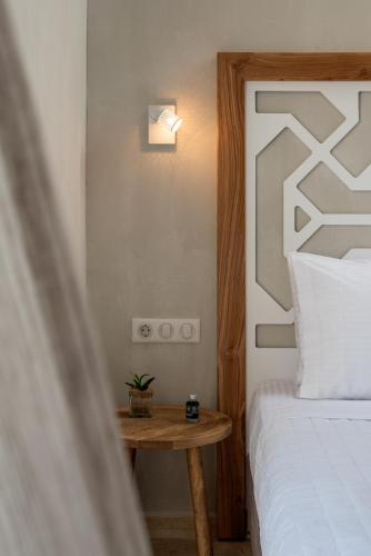 a bedroom with a bed and a small table at Apollo Plakias in Plakias